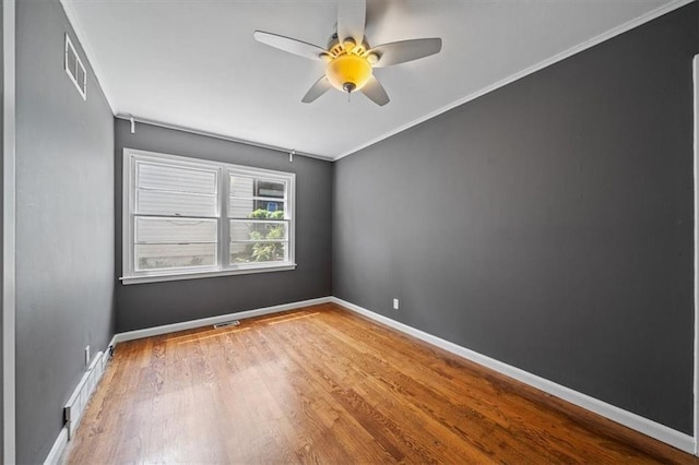 1822 Rankin Dr, Independence, MO 64055 - spare room with wood finished floors, ceiling fan, and ornamental molding