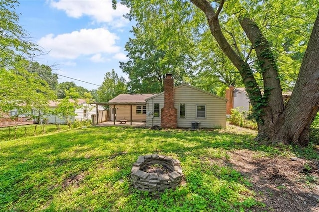 1822 Rankin Dr, Independence, MO 64055 - back of house featuring an outdoor fire pit, a patio area, and a chimney