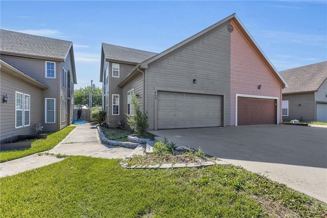 408 Eisenhower Rd, Baldwin City, KS 66006 - view of front of home featuring asphalt driveway, an attached garage, and a front yard