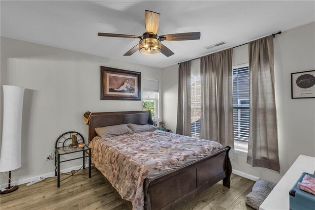408 Eisenhower Rd, Baldwin City, KS 66006 - bedroom with wood finished floors and a ceiling fan