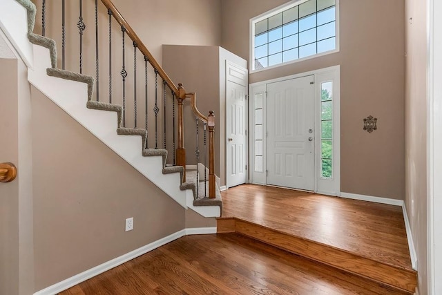 8110 W 144th Pl, Overland Park, KS 66223 - entrance foyer featuring wood finished floors, stairs, and a high ceiling