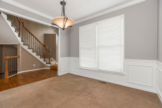 8110 W 144th Pl, Overland Park, KS 66223 - empty room featuring carpet floors, crown molding, wainscoting, and stairs