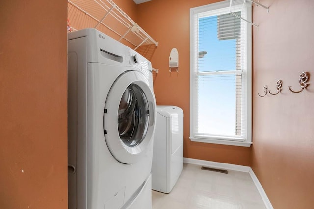 8110 W 144th Pl, Overland Park, KS 66223 - laundry area featuring washer and dryer and light floors