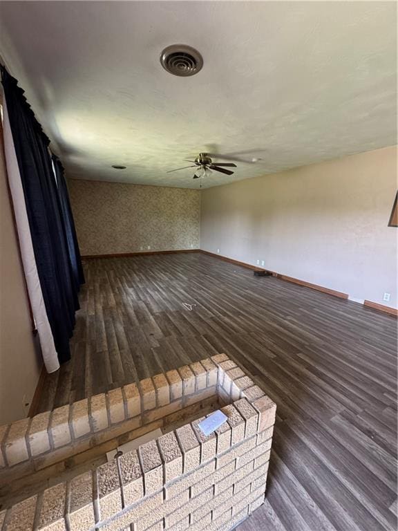 1110 S Plummer Ave, Chanute, KS 66720 - spare room featuring a ceiling fan, wood finished floors, and baseboards