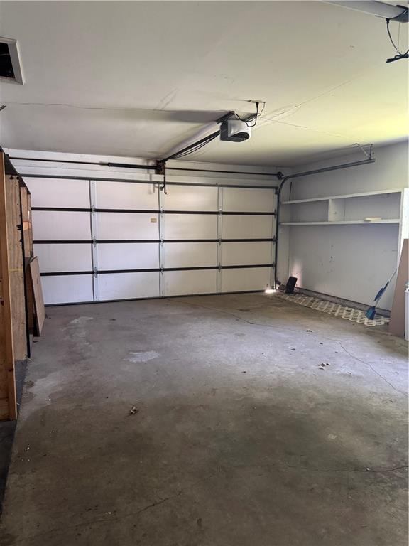 1110 S Plummer Ave, Chanute, KS 66720 - garage featuring a garage door opener