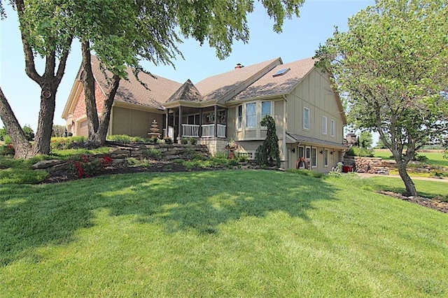 705 Sandpiper St, Raymore, MO 64083 - view of front of home featuring a front yard and board and batten siding