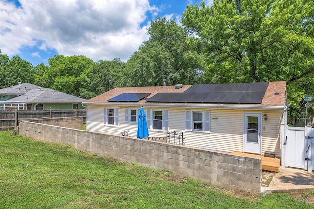 1401 Osage St, Leavenworth, KS 66048 - view of front of property featuring roof mounted solar panels, a fenced backyard, and a wooden deck