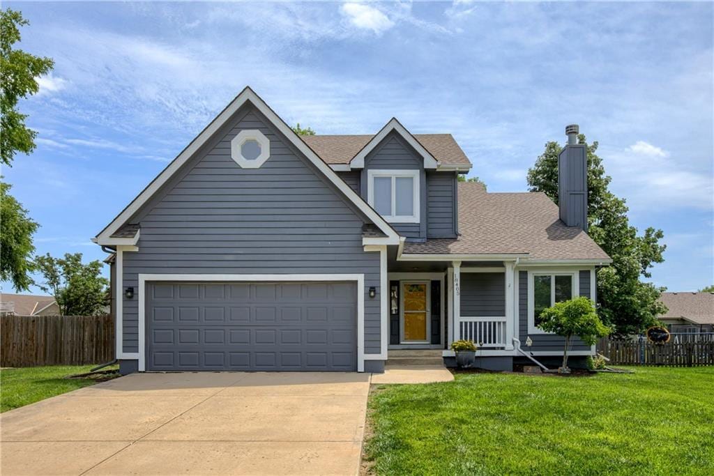 18405 Oak St, Gardner, KS 66030 - traditional home featuring concrete driveway, a chimney, covered porch, and a shingled roof