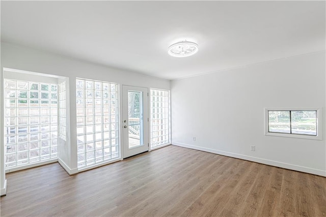 12600 Brooklyn St, Kansas City, MO 64146 - empty room featuring wood finished floors and healthy amount of natural light