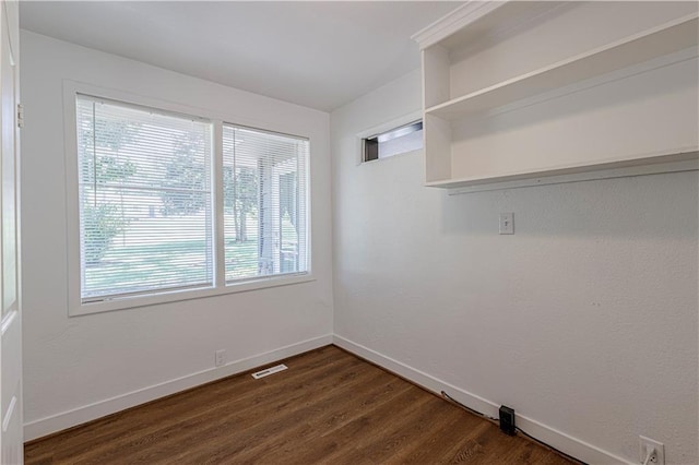 12600 Brooklyn St, Kansas City, MO 64146 - empty room with dark wood-style flooring and baseboards