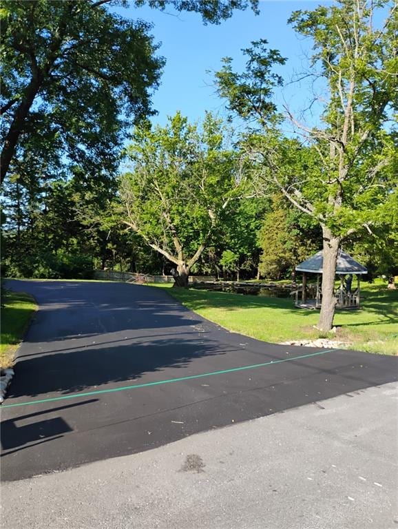12600 Brooklyn St, Kansas City, MO 64146 - view of asphalt road featuring view of wooded area