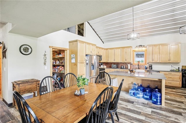 301 NW 1601st Rd, Kingsville, MO 64061 - dining space featuring wood finished floors and vaulted ceiling