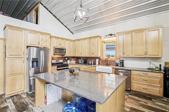 301 NW 1601st Rd, Kingsville, MO 64061 - kitchen featuring stainless steel appliances, light brown cabinets, a sink, dark stone countertops, and high vaulted ceiling
