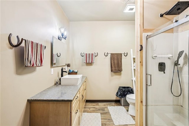 301 NW 1601st Rd, Kingsville, MO 64061 - full bath with vanity, toilet, a shower stall, wood finished floors, and baseboards