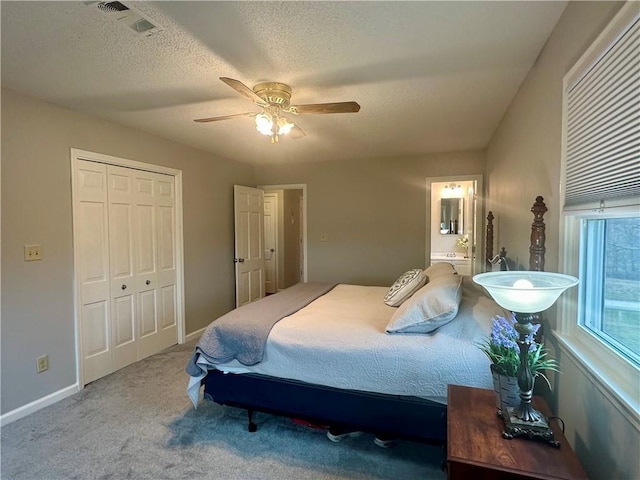 26609 S Red Bud Rd, Freeman, MO 64746 - bedroom with carpet, a closet, ceiling fan, connected bathroom, and a textured ceiling