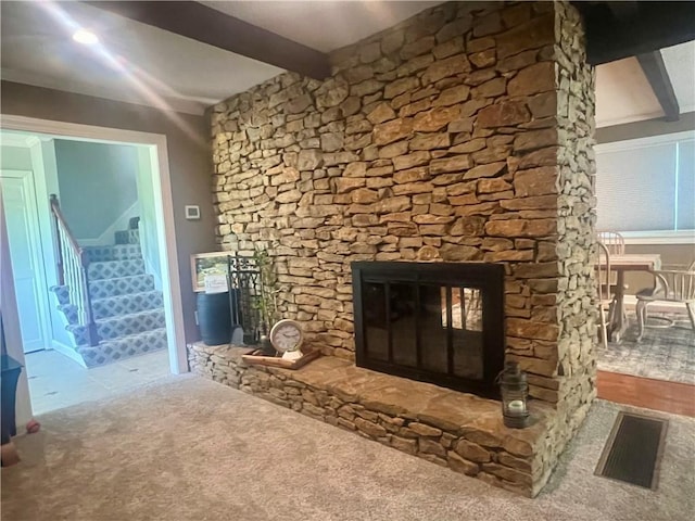 26609 S Red Bud Rd, Freeman, MO 64746 - unfurnished living room with a fireplace, carpet flooring, beam ceiling, and stairway