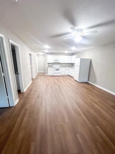 717 E Culton St, Warrensburg, MO 64093 - unfurnished living room with baseboards, wood finished floors, and ceiling fan