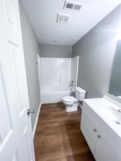 717 E Culton St, Warrensburg, MO 64093 - bathroom with toilet, vanity, shower / bath combination, wood finished floors, and baseboards