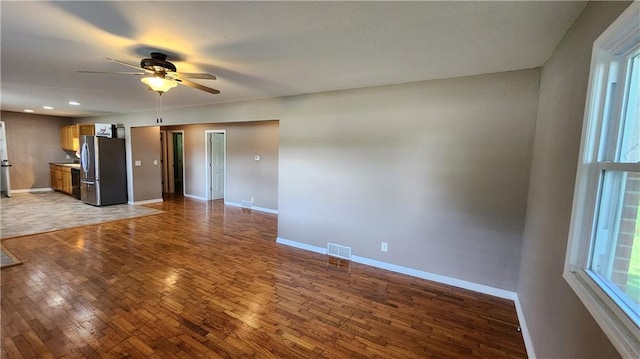 411 S Fulton St, Butler, MO 64730 - unfurnished living room with ceiling fan, wood finished floors, and recessed lighting