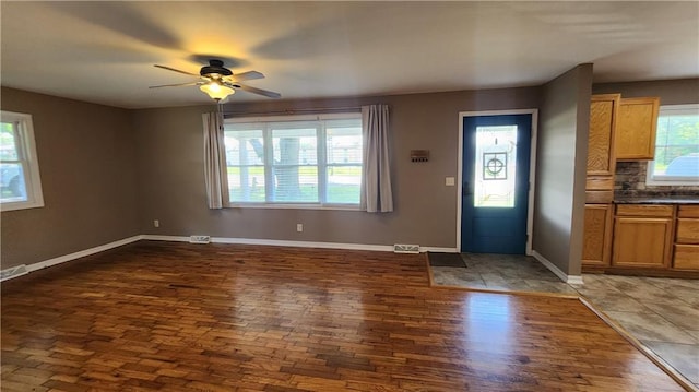 411 S Fulton St, Butler, MO 64730 - entrance foyer with ceiling fan and dark wood-type flooring