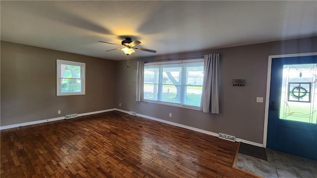 411 S Fulton St, Butler, MO 64730 - entrance foyer featuring plenty of natural light, a ceiling fan, and dark wood-style floors