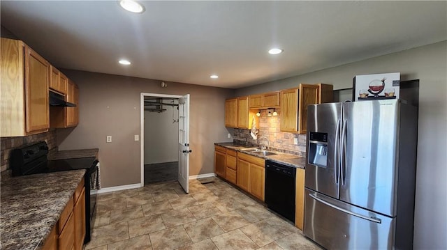411 S Fulton St, Butler, MO 64730 - kitchen featuring black appliances, under cabinet range hood, tasteful backsplash, and recessed lighting