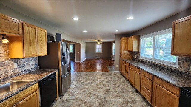 411 S Fulton St, Butler, MO 64730 - kitchen with dishwasher, backsplash, recessed lighting, dark countertops, and ceiling fan