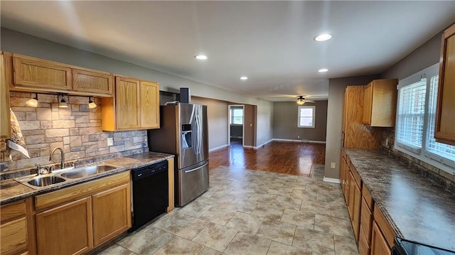 411 S Fulton St, Butler, MO 64730 - kitchen featuring black dishwasher, stainless steel fridge with ice dispenser, tasteful backsplash, dark countertops, and recessed lighting