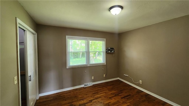 411 S Fulton St, Butler, MO 64730 - unfurnished room with dark wood-style floors and baseboards