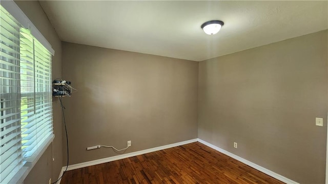 411 S Fulton St, Butler, MO 64730 - unfurnished room featuring healthy amount of natural light and dark wood-style floors