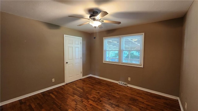 411 S Fulton St, Butler, MO 64730 - empty room with dark wood-style floors and ceiling fan
