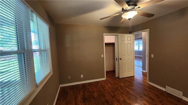 411 S Fulton St, Butler, MO 64730 - unfurnished bedroom featuring wood finished floors, a closet, and ceiling fan