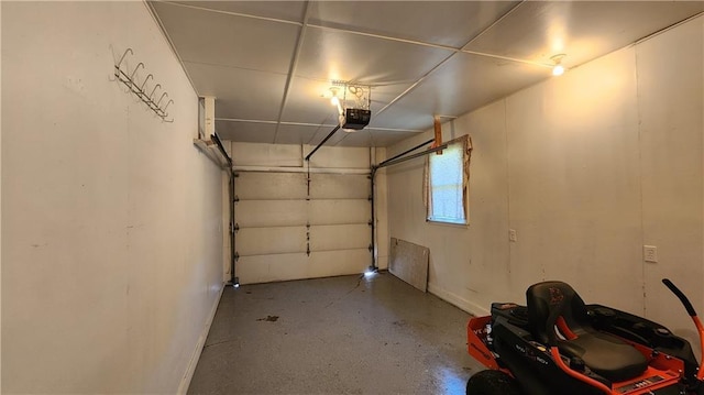 411 S Fulton St, Butler, MO 64730 - garage with a garage door opener and baseboards