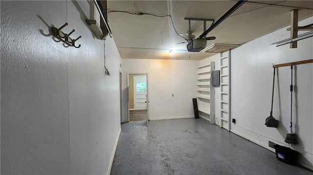 411 S Fulton St, Butler, MO 64730 - garage with a garage door opener and baseboards