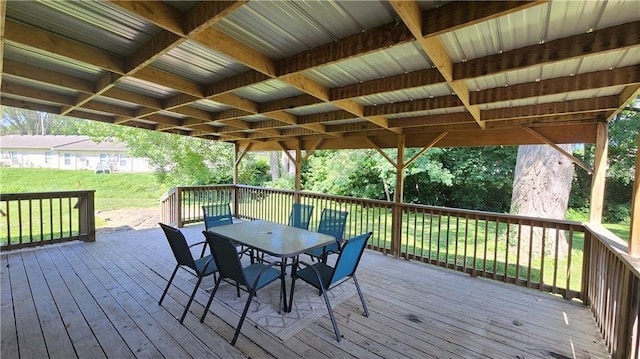 411 S Fulton St, Butler, MO 64730 - wooden terrace featuring outdoor dining area and a lawn