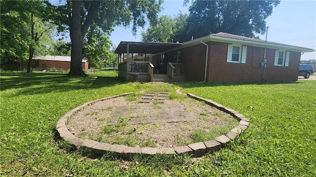 411 S Fulton St, Butler, MO 64730 - view of home's exterior with a lawn and brick siding