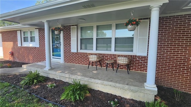 411 S Fulton St, Butler, MO 64730 - view of exterior entry with brick siding and covered porch