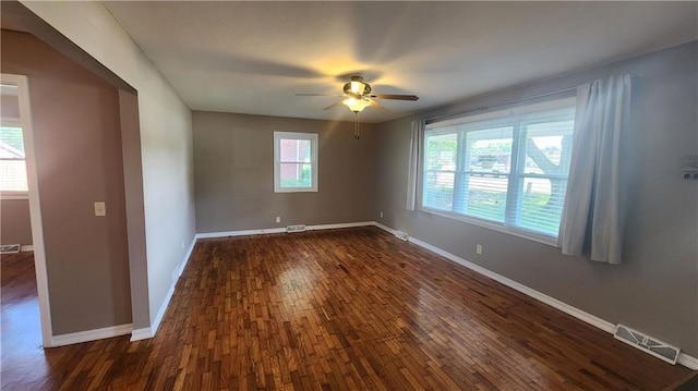 411 S Fulton St, Butler, MO 64730 - empty room featuring dark wood-type flooring and ceiling fan