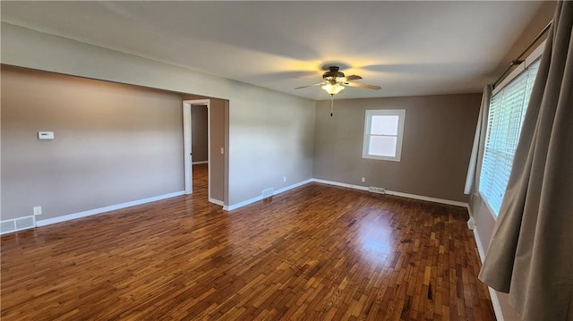 411 S Fulton St, Butler, MO 64730 - empty room featuring a ceiling fan and dark wood finished floors