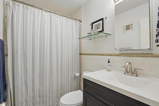 8604 Sagamore Rd, Leawood, KS 66206 - bathroom with a textured wall, vanity, a shower with curtain, tile walls, and wainscoting