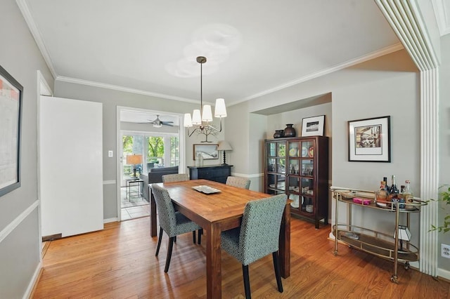 8604 Sagamore Rd, Leawood, KS 66206 - dining space with ornamental molding, a chandelier, and light wood-style floors