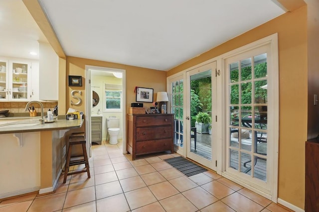 8604 Sagamore Rd, Leawood, KS 66206 - doorway featuring a sink and light tile patterned floors