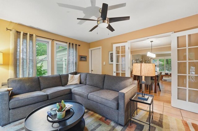 8604 Sagamore Rd, Leawood, KS 66206 - living area featuring french doors, a chandelier, a ceiling fan, and light tile patterned flooring