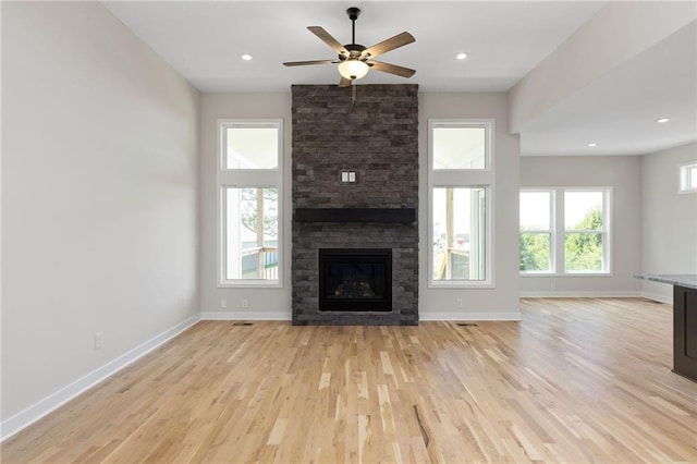 31501 W 86th Ct, De Soto, KS 66018 - unfurnished living room with light wood finished floors, a fireplace, ceiling fan, and recessed lighting