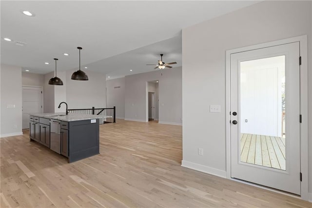 31501 W 86th Ct, De Soto, KS 66018 - kitchen with stainless steel dishwasher, light wood-style floors, hanging light fixtures, ceiling fan, and recessed lighting