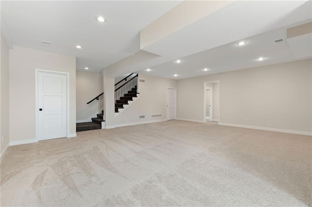 31501 W 86th Ct, De Soto, KS 66018 - below grade area featuring light carpet, stairs, and recessed lighting
