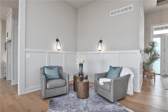 6113 Barth Rd, Shawnee, KS 66226 - living area featuring a decorative wall, wood finished floors, and a wainscoted wall