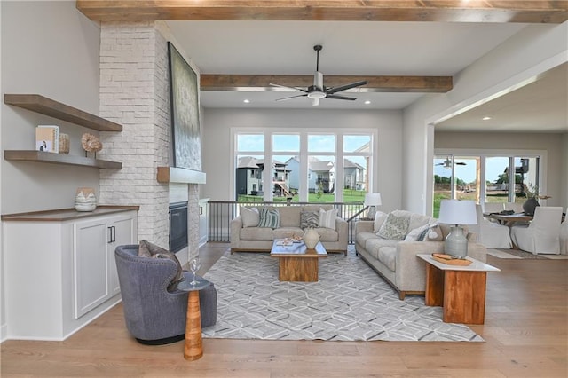 6113 Barth Rd, Shawnee, KS 66226 - living area with ceiling fan, beamed ceiling, light wood-type flooring, a large fireplace, and recessed lighting