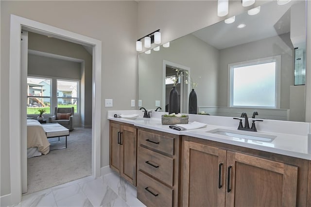 6113 Barth Rd, Shawnee, KS 66226 - full bathroom featuring double vanity, plenty of natural light, marble finish flooring, and ensuite bath
