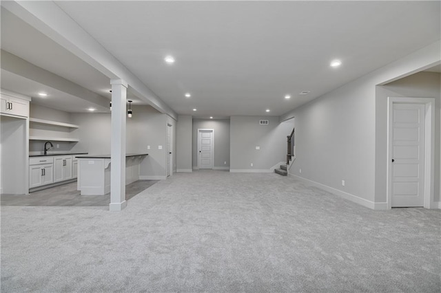 6113 Barth Rd, Shawnee, KS 66226 - unfurnished living room with light colored carpet, recessed lighting, wet bar, and baseboards